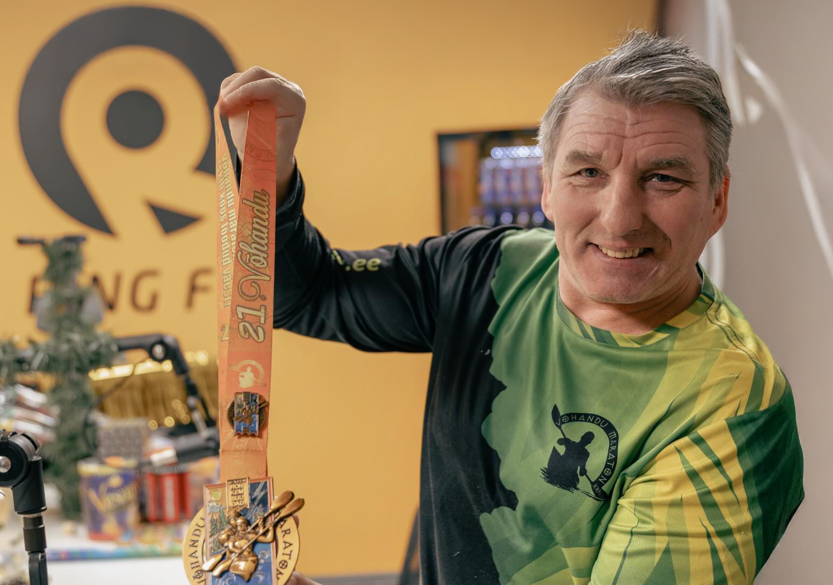 Võhandu maratoni peakorraldaja Hillar Irves näitamas 2026. aasta maratoni medalit. Foto: AIGAR NAGEL